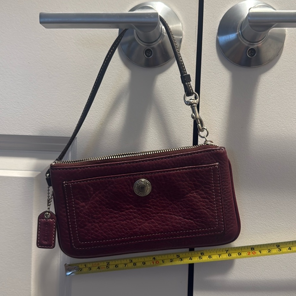 Never used maroon Coach wristlet.
